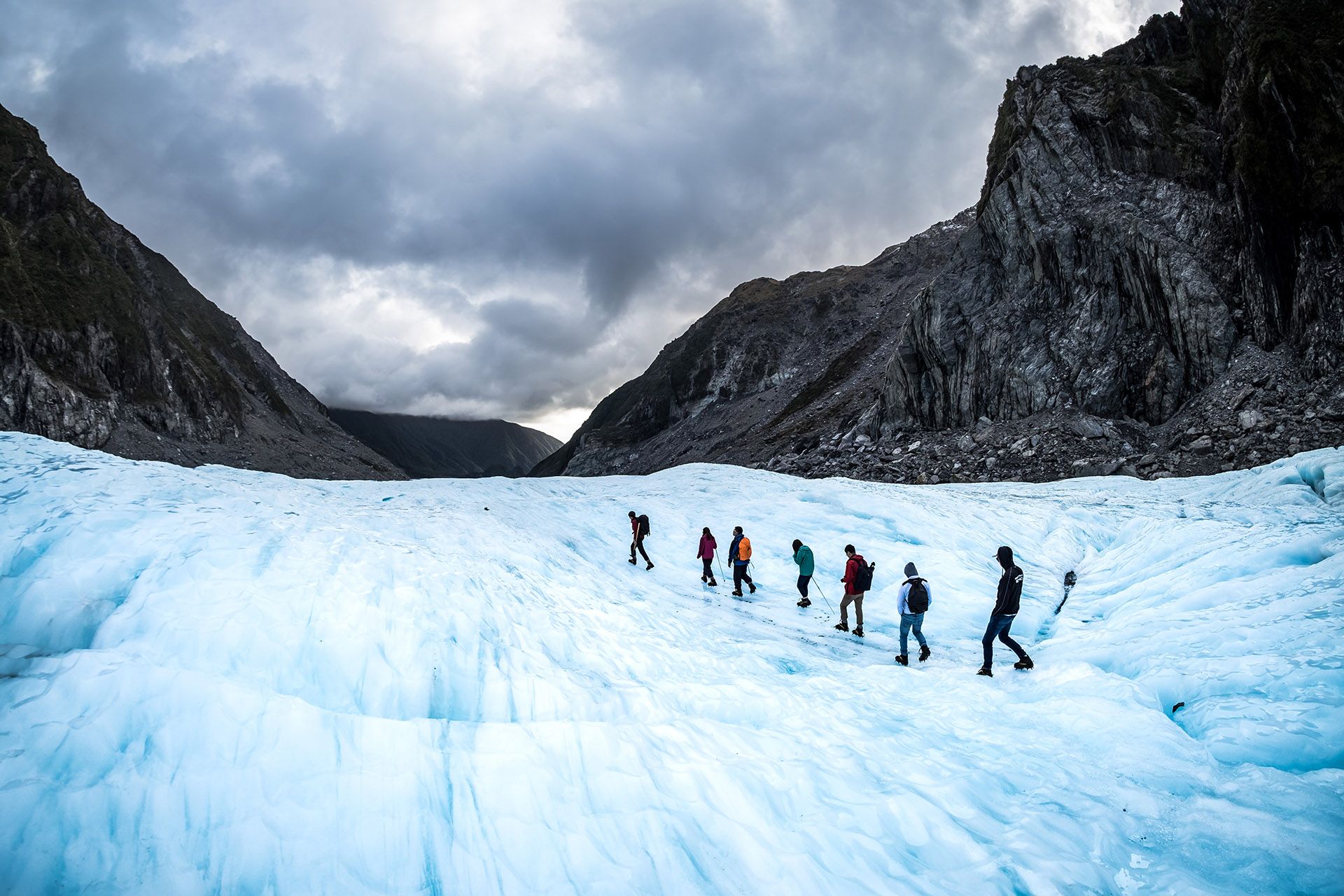 Hikers and travelers walking on ice in Fox Glacier, New Zealand © SkyImages/Shutterstock